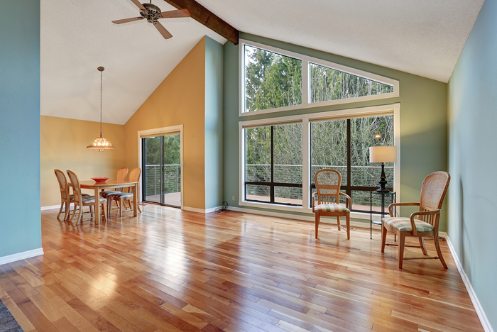 Large dinning area with hardwood floor and big windows 